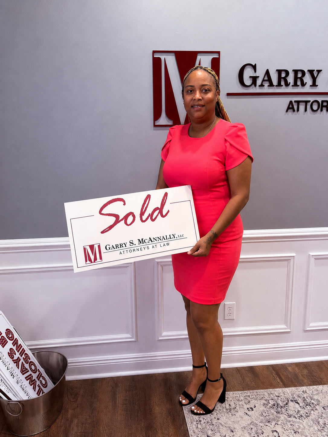 Mo holding Sold sign at closing